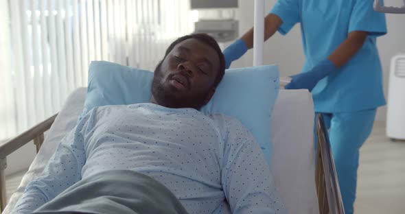Medical Staff Pushing Emergency Stretcher Bed with Afroamerican Sick Man alt