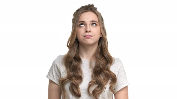 Portrait of European Woman 20s Apathetically Rolling Her Eyes Being Tired of Conversation or Person alt