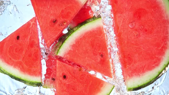 Super Slow Motion Shot of Splashing Fresh Melon Cuts Into Water at 1000 Fps alt
