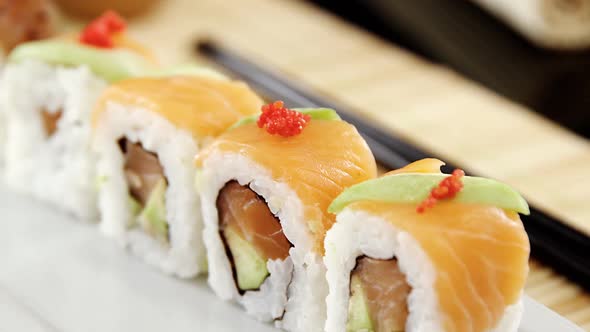 Sushi on mat with chopsticks alt