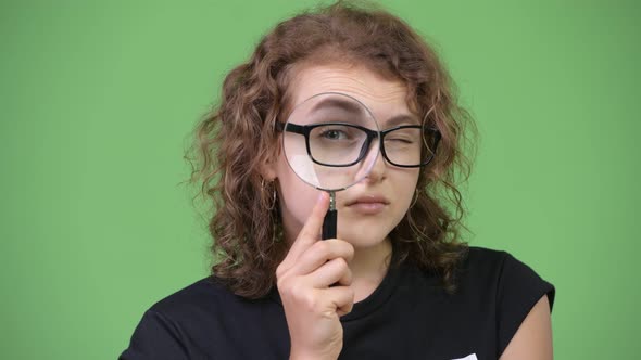Young Beautiful Nerd Woman Using Magnifying Glass alt