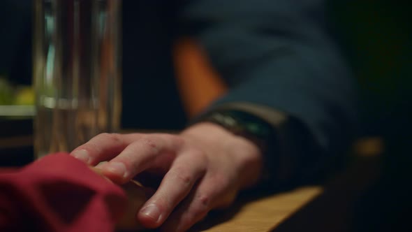 Supporting Couple Holding Hands on Romantic Dinner Date at Restaurant Table alt