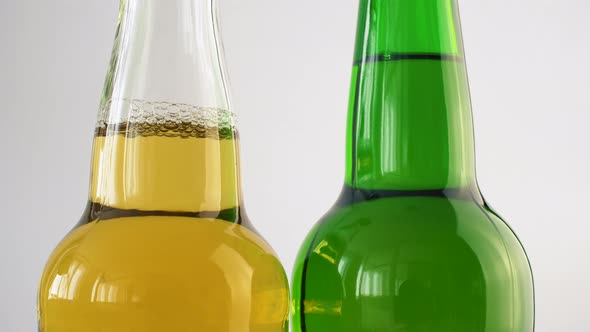 Two bottle of beer rotating on white isolated background