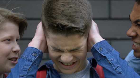 Cruel Multiethnic Students Cursing Depressed Classmate, Boy Suffering Bullying alt
