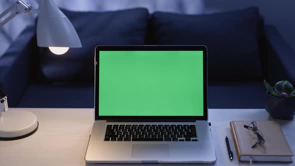 Modern Laptop With Mock Up Chroma Key Green Screen on Table of Living Room