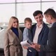 Family in Auto Show Happy Parents with Male Child Talking to Car Salesman About New Automobile Model - VideoHive Item for Sale