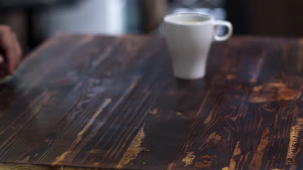 Customer making contactless payment by paying with electronic wristwatch alt