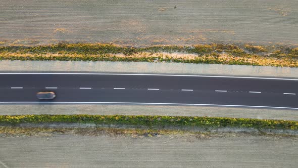 Aerial View of Intercity Road with Fast Driving Cars at Sunset alt
