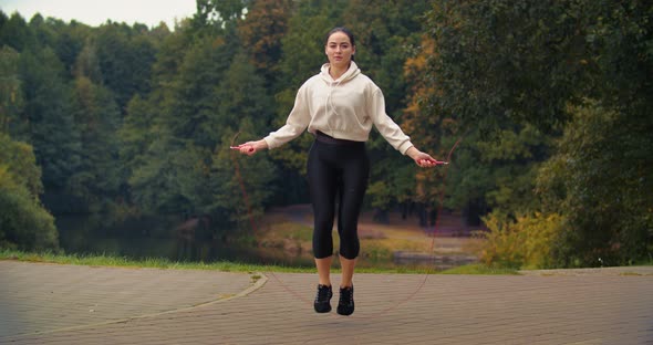 Fitness Woman with Jump Rope Training Outdoors in the Morning. 