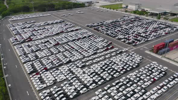 Aerial top view of new cars parking for sale stock lot row, dealer inventory import alt