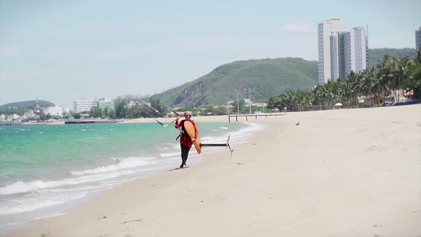 Acrobatic Jump of a Professional Kitesurfer Who Jumps From the Sea Wave Onto the Beach Sand on His alt
