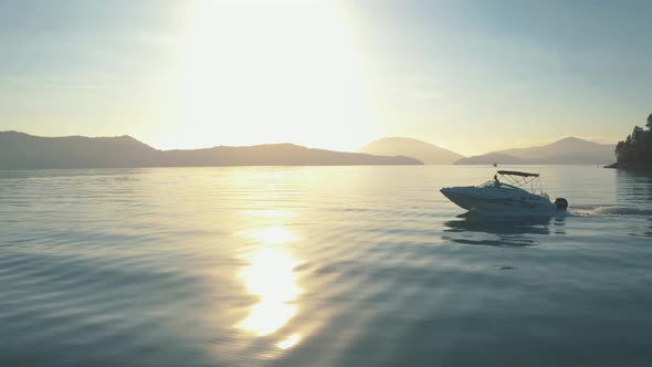 Drone video - Aerial - Speedboat sailing on a beautiful sunrise