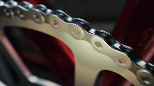 Bicycle over a black background. Loopable shot of spinning chain and chainring. alt