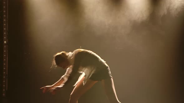 Woman in a White Shirt and Shorts Is Dancing the Dramatic Dances of Modern Ballet. The Ballet Dancer alt