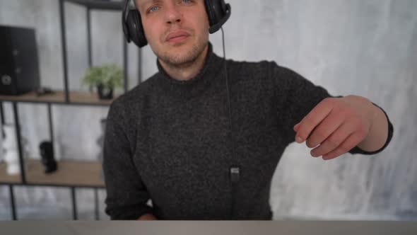 POV Video a Young Man with Headphones on His Head Adjusts the Camera alt