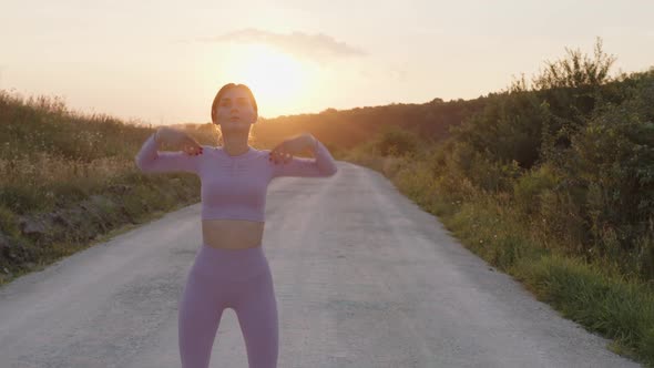 Girl is Making Some Exercises Outdoor alt
