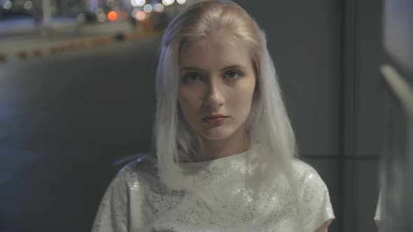 Slow Motion with Blur Tired Young Adorable Woman Bends Her Head Against the Glass Wall Against the alt