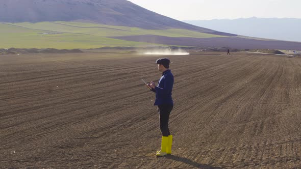 Tractor agrochemical Agricultural spraying. Modern farmer tablet use. alt