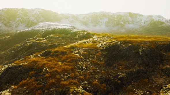 Beautiful Scenic Sunset View at Mountain Range and Dry Yellow Grass in Front alt