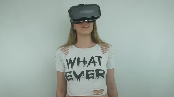 Young Sexy Woman Uses A Virtual Reality Helmet And Full Immersion Technology