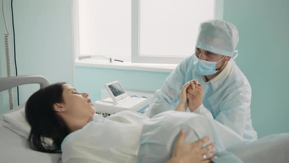 Pregnant Woman Holding Husband Hand Before Labour alt