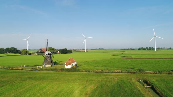 Windmill and wind turbines in field, Tjerkwerd, Nederland