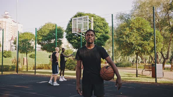 Portrait of a Black Basketball Player with a Ball alt