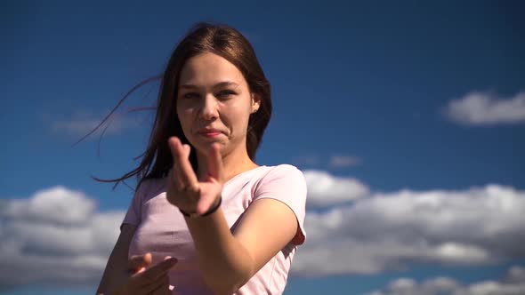 Young and Attractive Girl or Young Woman in Pink T-shirt Show Follow Me Gesture alt