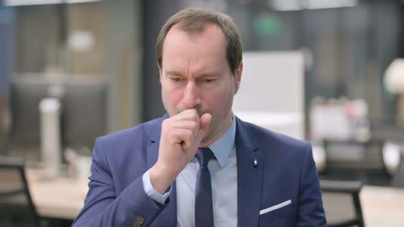 Portrait of Sick Businessman Coughing alt