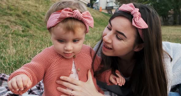 Mother and a Small Daughter, Spends Time Together in a City Park on a Picnic, Young Woman and Little