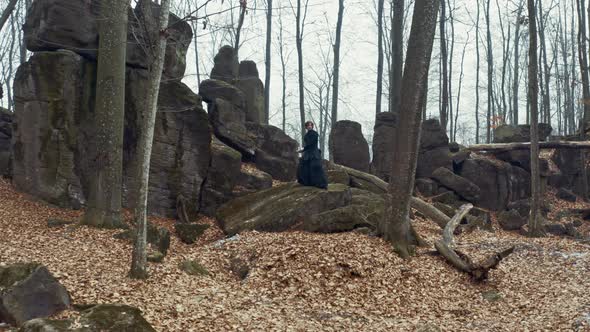 Man in Traditional Japanese Clothes, with a Sword, a Katana, Trains Martial Arts in the Forest alt