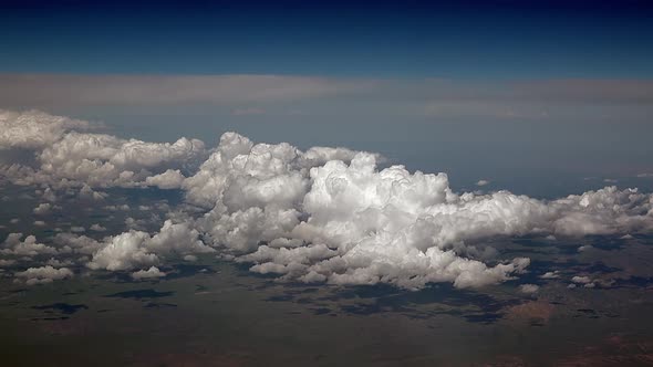 Airplane View of Partly Cloudy and Cumulus Clouds Condensed in Clusters in Humid Warm Air alt