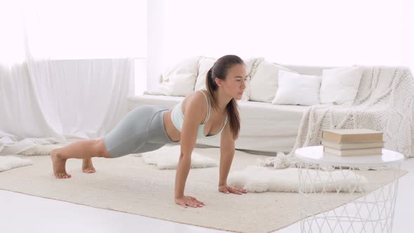 Young Woman Is Doing Yoga Poses in Dynamic, Down Face Dog and Upward Dog Poses.