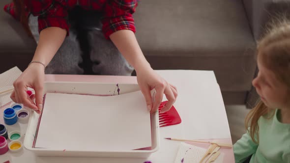 Artist Covers Tray with Ebru Art Mix at Lesson for Girl alt