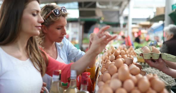 Young Happy Women Shopping Vegetables and Fruits on the Market