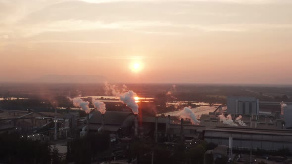 Aerial view Drone shot of flying around toxic chimneys tubing. Air Pollutants, Industrial zone