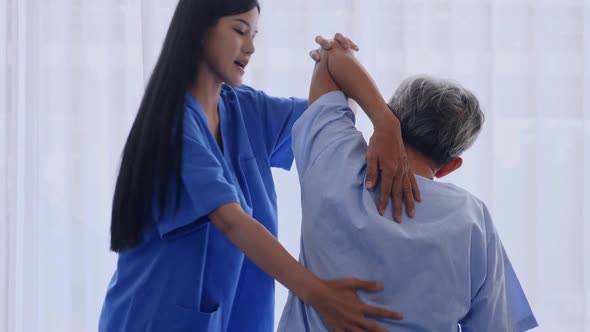 Physiotherapist working with elderly patient in clinic