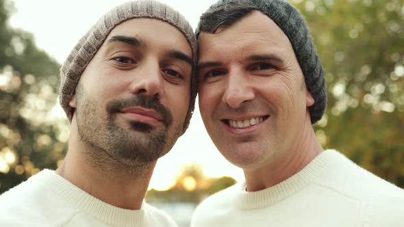 Authentic Shot of LGBT Gay Men Couple Having Tender Moment Outdoor at City Park alt