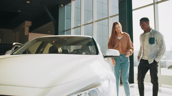 African American Man and Caucasian Woman While Walking at Modern Auto Center alt