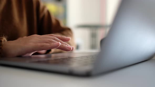 Closeup a woman working and touching on laptop computer touchpad on the table