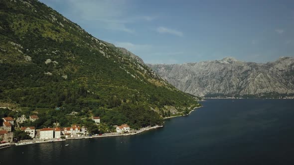 Aerial view of city Perast in Montenegro. Flying over the Kotor Bay and mountains alt