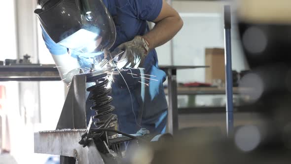 Welding Process. Welder In Helmet Works, Worker Works In The Auto Workshop