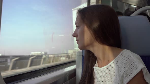 Sad girl on the train by the window