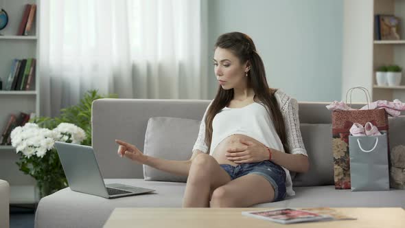 Female Pregnant With Kid Looking at Laptop Screen, Buying Items Online, Shopping alt