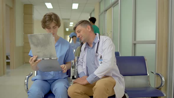 Doctor explaining patient diagnosis to one of female medical student for advice about the sickness  alt