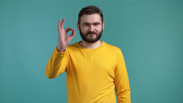 Handsome Man in Yellow Wear Shows Okay Ok Gesture alt