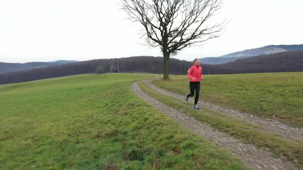 Aerial View Woman Jogging in Wide Rural Landscape
