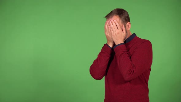 A Middleaged Man Covers His Eyes with His Hands Then Uncovers Them Looks in Awe  Green Screen