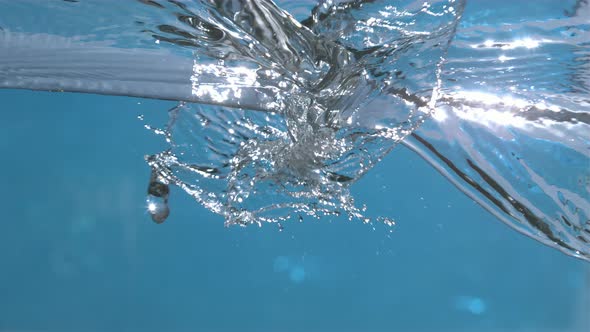 Pure Water Waves Splashing On Blue Background In Slow Motion 4k alt