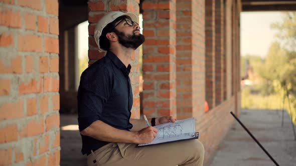 Civil Engineer Architect Construction Site. Engineer Developer In Helmet Inspecting Building. alt